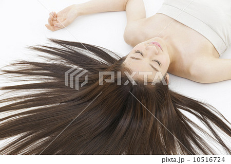女性 寝る 眠る 仰向け 笑顔 かわいい 屋内 代 長髪の写真素材