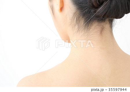 Close up view on the back of a female neck on a woman with her hair