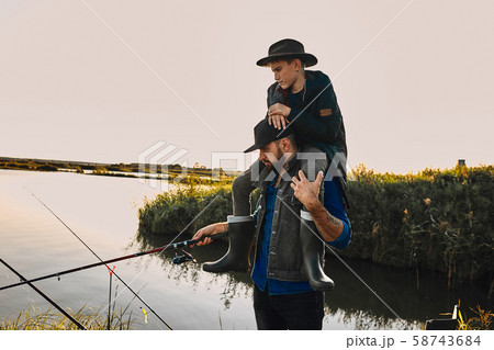 The first joint fishing of adult father and teen son in warm