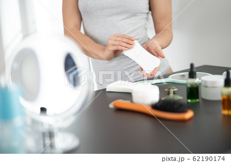 Woman trying to earing sanitary napkins or menstruation pad with