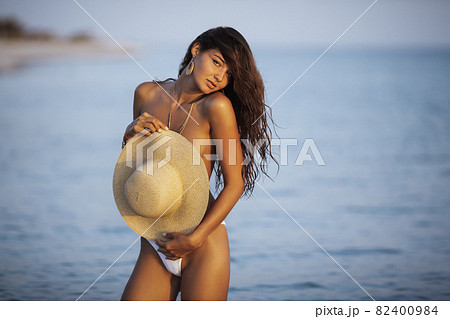 Naked women in panties hugging on beach - Stock Photo [84277115