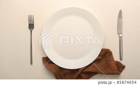 Wedding table arranged with golden cutlery and white charger plate