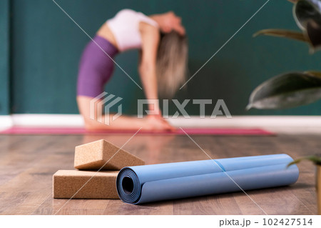 Young Woman Practices Side Plank Asanas with Yoga Blocks. Pilates